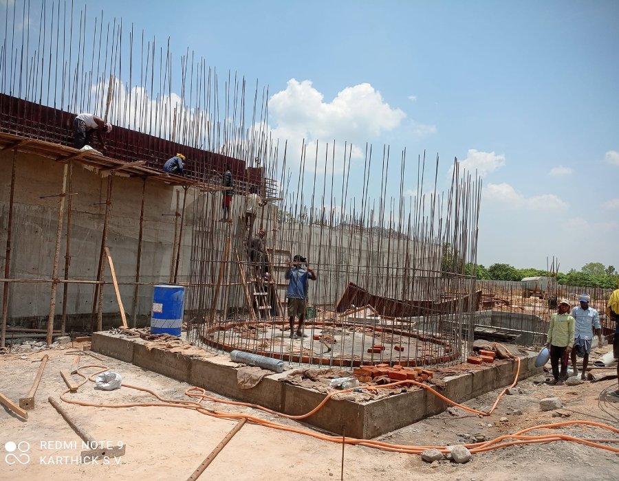 Freshly poured concrete foundation and rebar at a job site